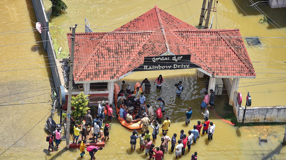 Fire fighters evacuate residents from flooded Rainbow Drive Layout at Sarjapur after heavy monsoon rains, in Bengaluru on Monday. The rescue operations continued on Tuesday, September 6, 2022.