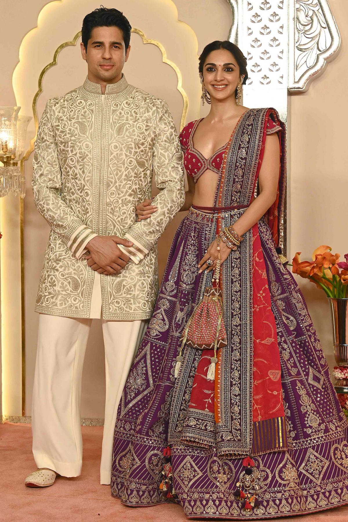 Bollywood actors Sidharth Malhotra and his wife Kiara Advani pose for photos as they arrive to attend the wedding ceremony of Anant Ambani (son of billionaire tycoon and Chairman of Reliance Industries Mukesh Ambani) and Radhika Merchant in Mumbai, on July 12, 2024 Bollywood actors Sidharth Malhotra and his wife Kiara Advani pose for photos as they arrive to attend the wedding ceremony of Anant Ambani (son of billionaire tycoon and Chairman of Reliance Industries Mukesh Ambani) and Radhika Merchant in Mumbai, on July 12, 2024