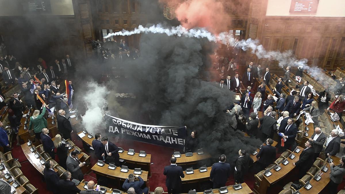 Serbia’s Parliament descends into chaos, at least three lawmakers injured as smoke bombs and flares thrown