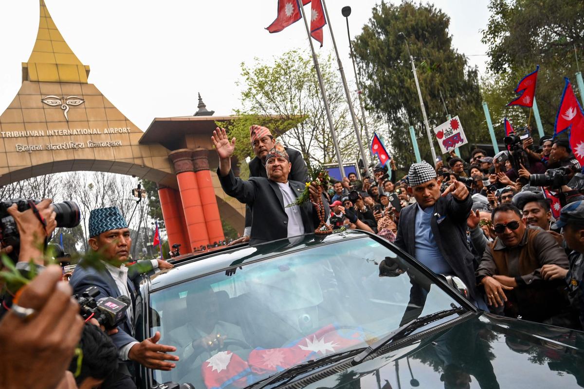 Nepal's former King Gyanendra Bir Bikram Shah Dev waves as he arrives at Tribhuwan International Airport in Kathmandu on March 9, 2025. Nepal's former King Gyanendra Bir Bikram Shah Dev waves as he arrives at Tribhuwan International Airport in Kathmandu on March 9, 2025.