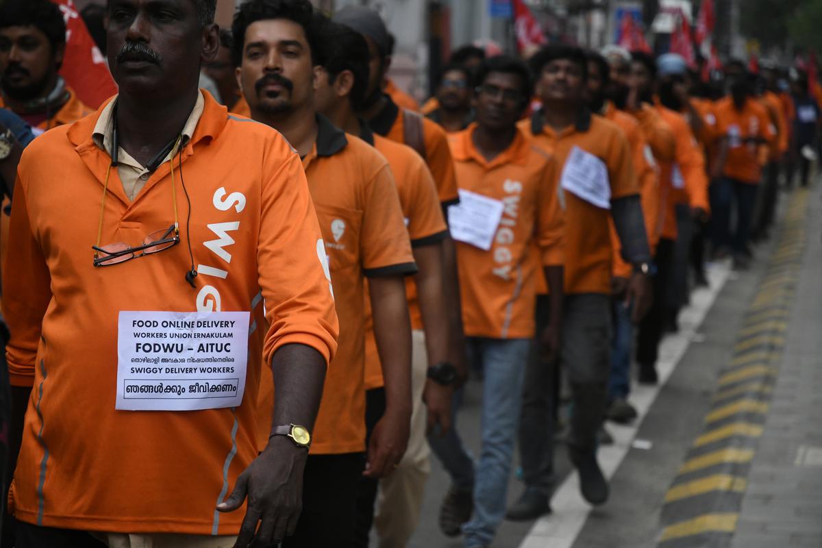 Online food delivery workers take out a protest march to the office of the food delivery company Swiggy in Kochi recently. Around 4,000 workers are on an indefinite strike by in Ernakulam district.