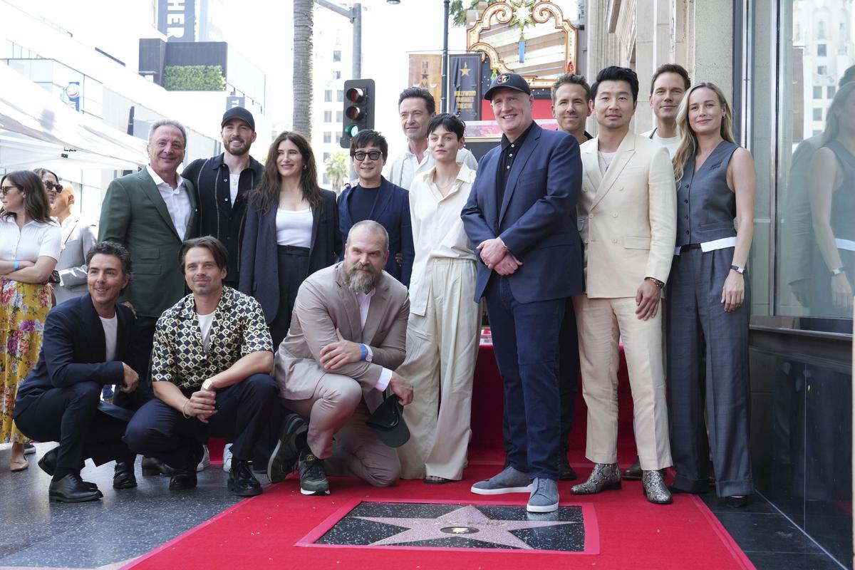 Shawn Levy, from left, Louis D’Esposito, Sebastian Stan, Chris Evans, Kathryn Hahn, David Harbour, Ke Huy Quan, Hugh Jackman, Emma Corrin, Kevin Feige, Ryan Reynolds, Simu Liu, Chris Pratt and Brie Larson attend a ceremony honoring Feige with a star on the Hollywood Walk of Walk of Fame on Thursday