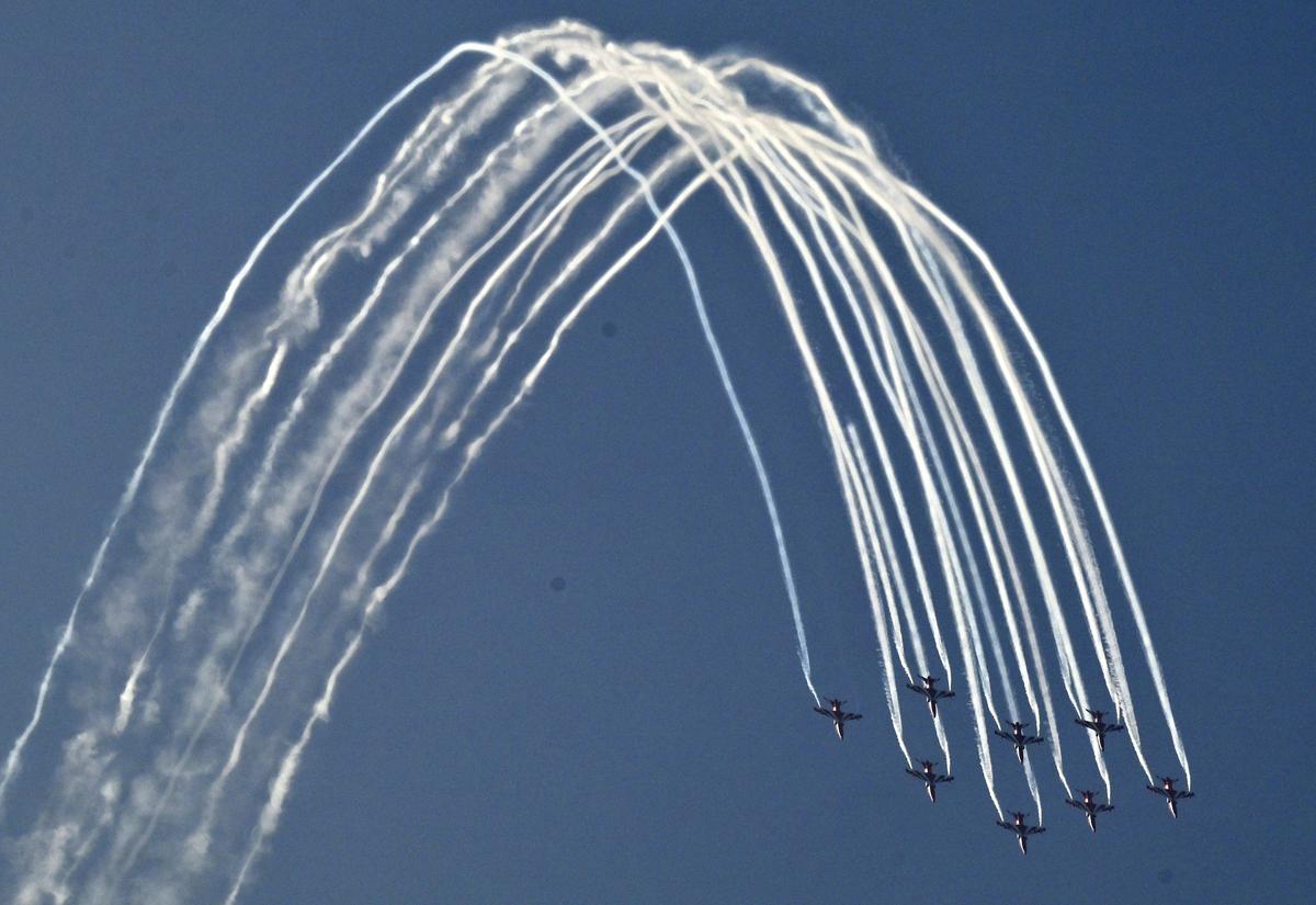 Surya Kiran Aerobatic Team in the sky over Dr. B.R. Ambedkar State Secretariat building complex in Hyderabad on Friday.