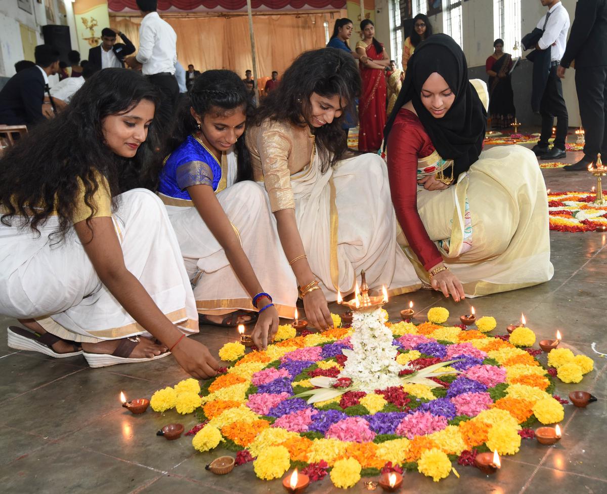 Women in traditional Kerala kasavu saree for Onam celebrations at a college in Mangaluru, 2019. 