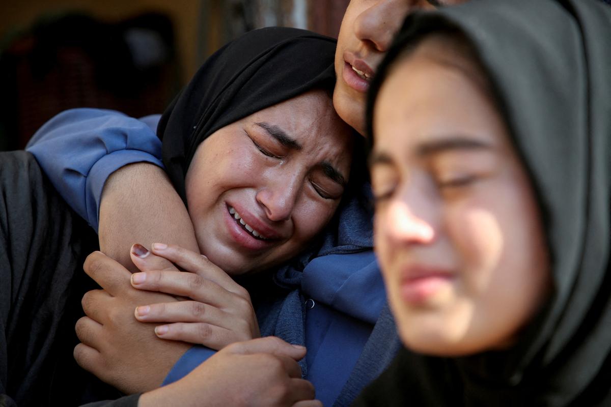 Relatives of a Palestinian killed in an Israeli strike react at the site of the strike, near a school sheltering displaced people, amid the Israel-Hamas conflict, in Khan Younis in the southern Gaza Strip on July 10, 2024. 