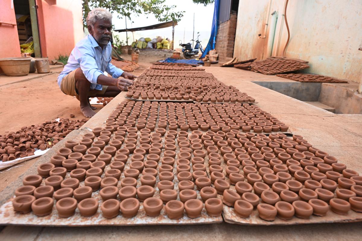 Palaniswamy is making clay lamps at Paravai, Madurai. Palaniswamy is making clay lamps at Paravai, Madurai.