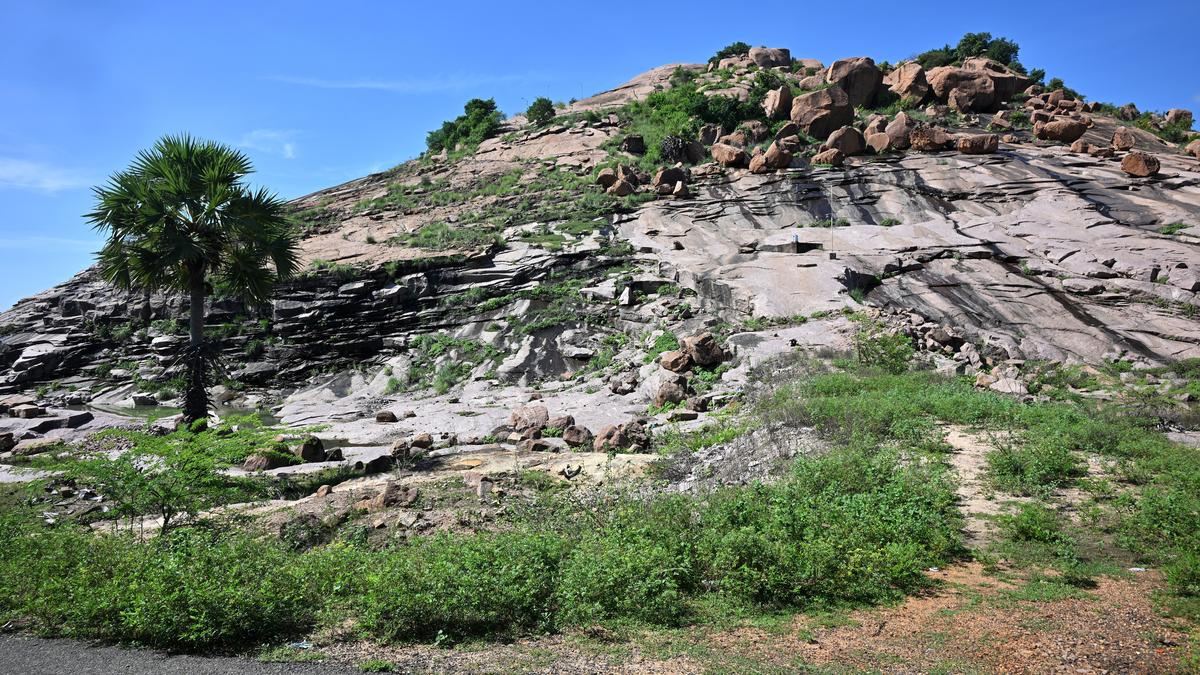 At a hillock known for its Shiva temple, Jain beds lie hidden under an overhanging ledge