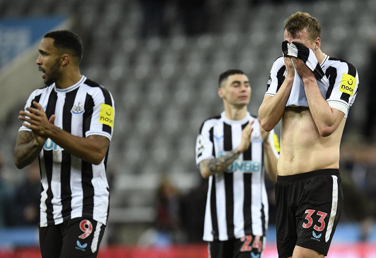 Newcastle United’s English striker Callum Wilson (L) and Newcastle United’s English defender Dan Burn (R) react at the end of the English Premier League football match between Newcastle United and West Ham United at St James’ Park in Newcastle-upon-Tyne, north east England on February 4, 2023. The match ended 1-1. 