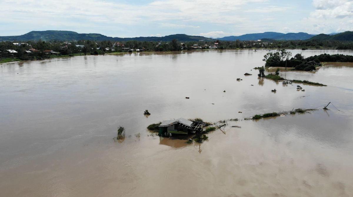 This aerial photo shows a building submerged in flooding in Dak Lak, Vietnam on Friday, Nov. 7, 2025 after Typhoon Kalmaegi lashed Vietnam with fierce winds and torrential rains.