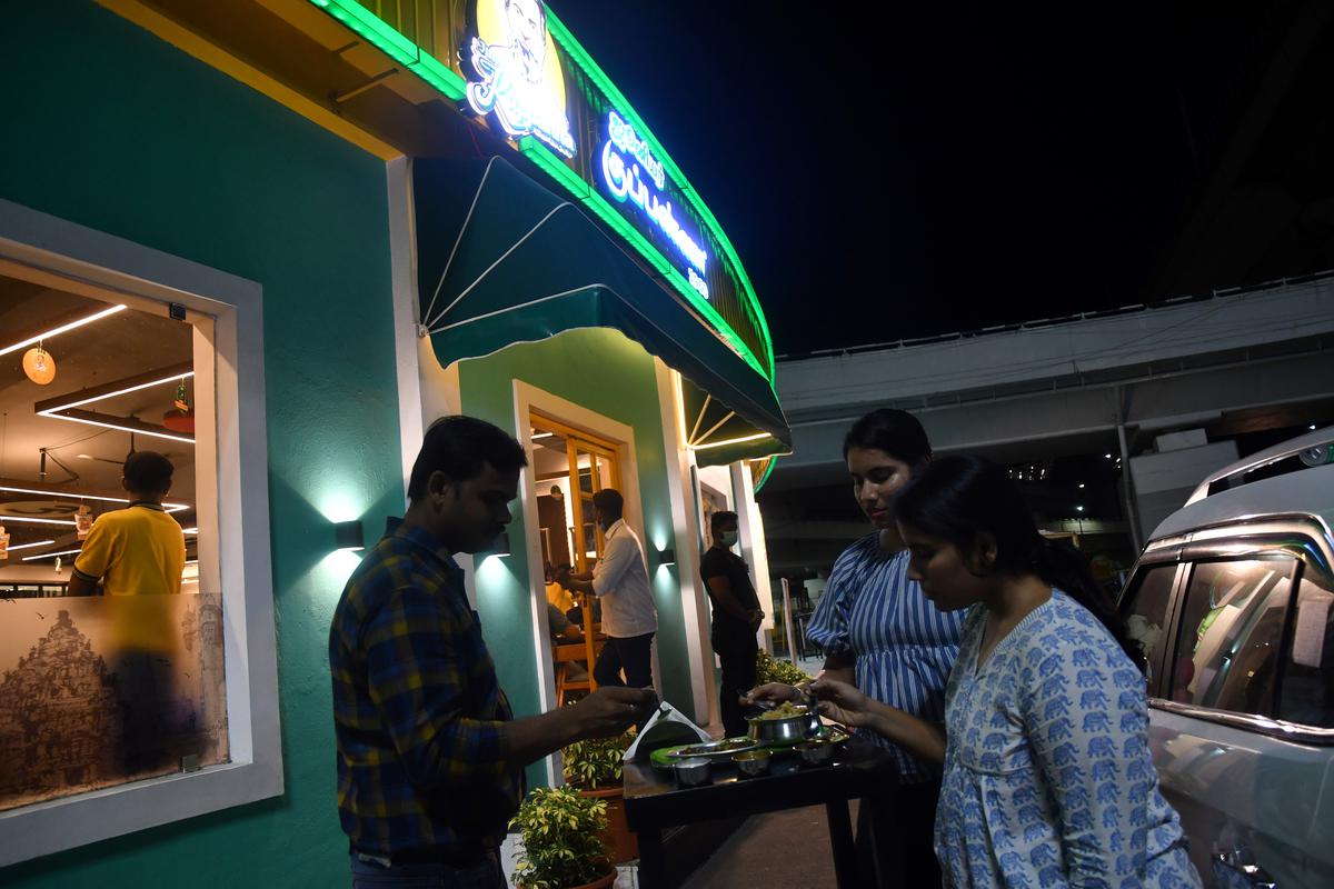 Diners enjoying late night dinner at the outdoor dining at the Junior Kuppanna 24-hour drive-in 