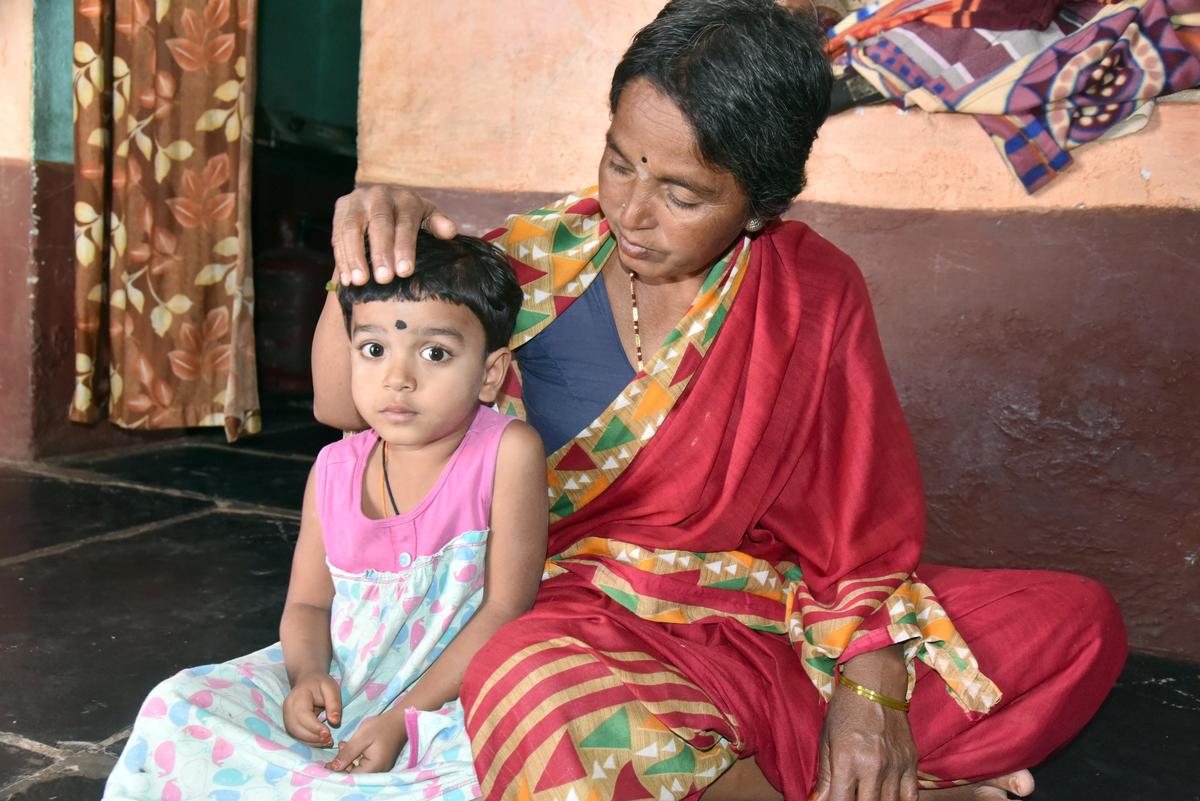 Mahalakshmi with her four-year-old granddaughter, at her house in Kalugotla village near Yemmiganur of Kurnool district. 