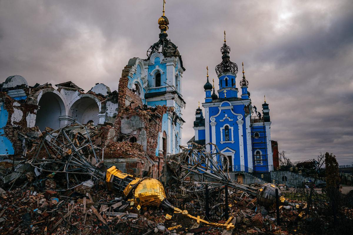 Construction workers climb onto the roof of a destroyed church in the village of Bohorodichne amid Russia's invasion of Ukraine.  The Russian army launched a heavy assault on Bohorodichen in the Donetsk region.