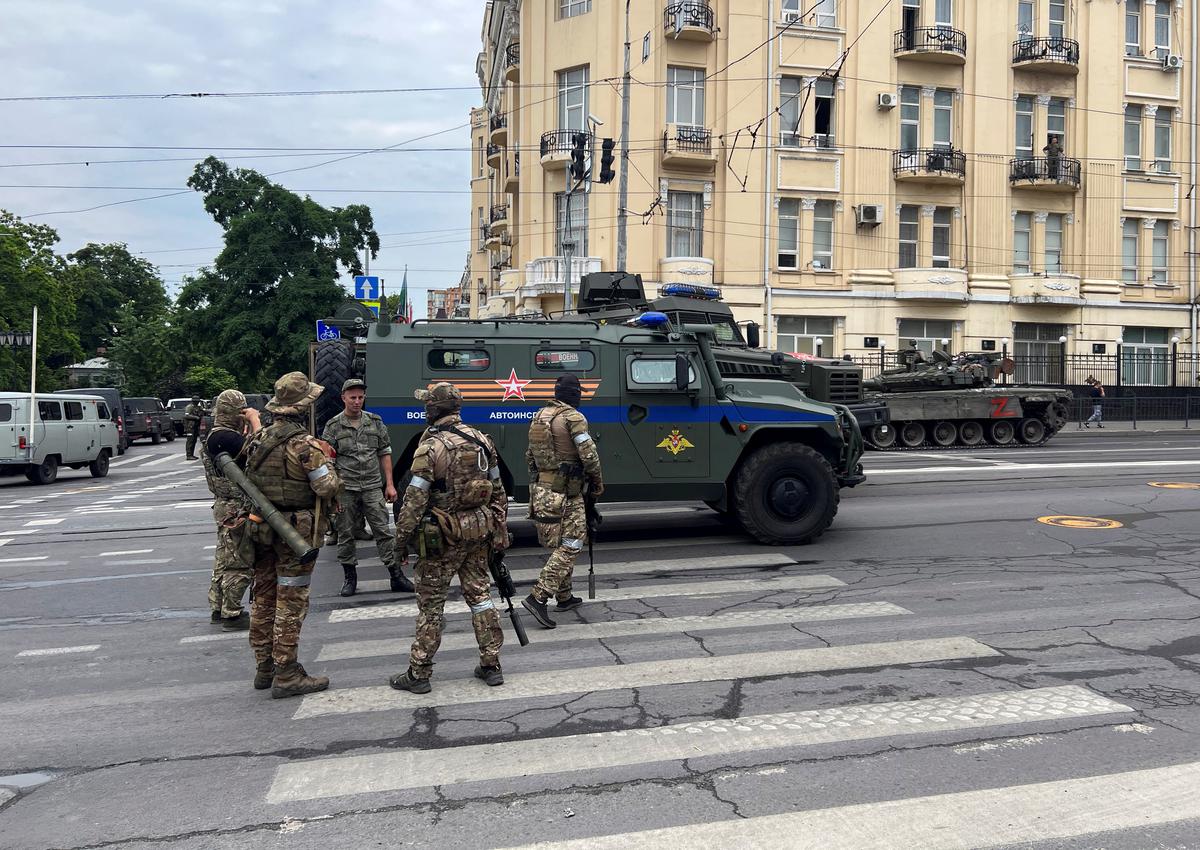 Fighters of Wagner private mercenary group speak with a Russian service member in a street near the headquarters of the Southern Military District in the city of Rostov-on-Don, Russia, on June 24, 2023. 