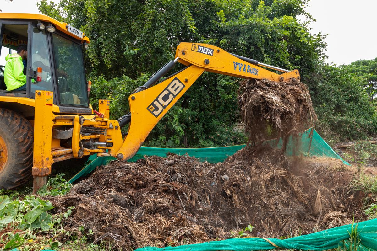 A compost pit being turned as part of the City-Farmer Partnership for Solid Waste Management at Chickballapur.