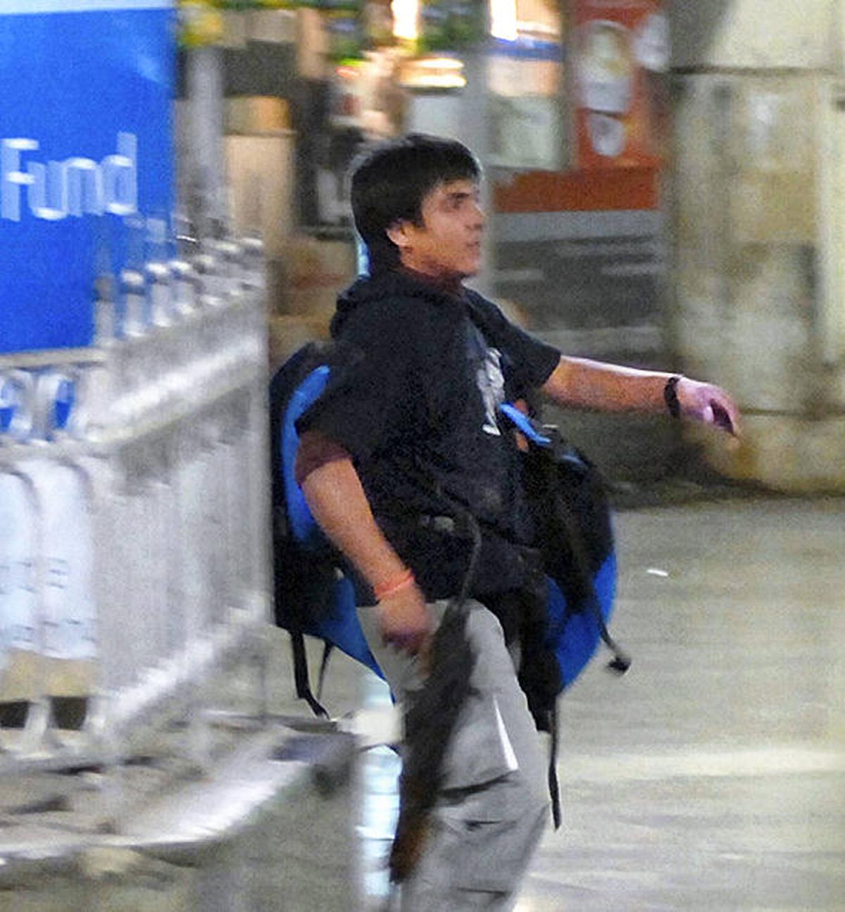 In this Wednesday, Nov. 26, 2008 file photo, the armed terrorist Mohammed Ajmal Kasab walks at the Chatrapathi Sivaji Terminal railway station in Mumbai. 