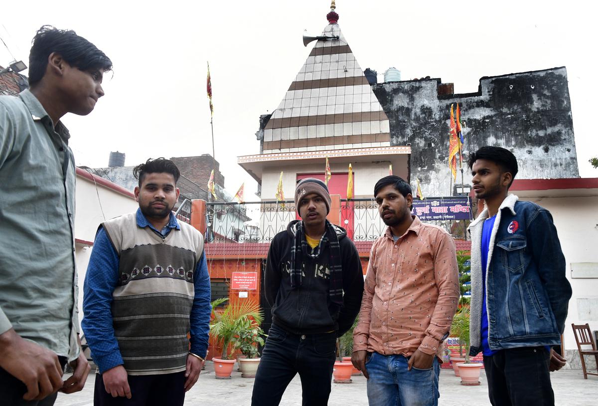 Anurag Gupta, 20, (centre) whose grandfather donated money towards building a Durga temple, close to 50 years ago, says the issue is indeed politically motivated. 
