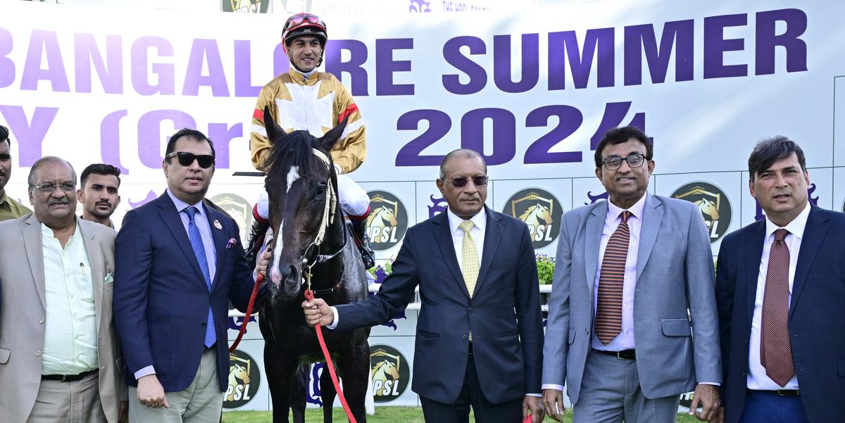 Owners Gautam P. Lala, Kishore Rungta, Joydeep Datta Guta, Achuthan Siddharth along with trainer P. Shroff, right, leading in Santissimo (S. Saqlain astride) after the the win in the HPSL Bangalore Summer Derby.