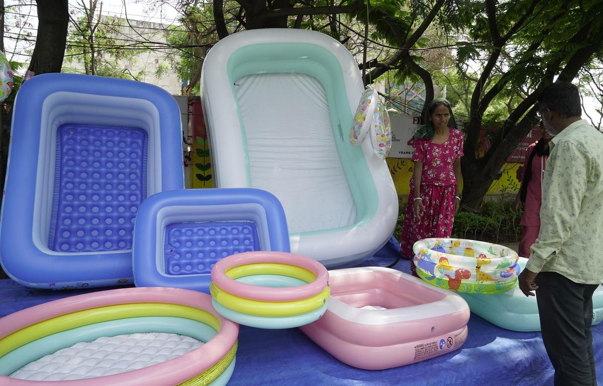 A vendor displays inflatable pools and swim rings at a roadside stall in Raidurg, as demand rises with the onset of summer heat.