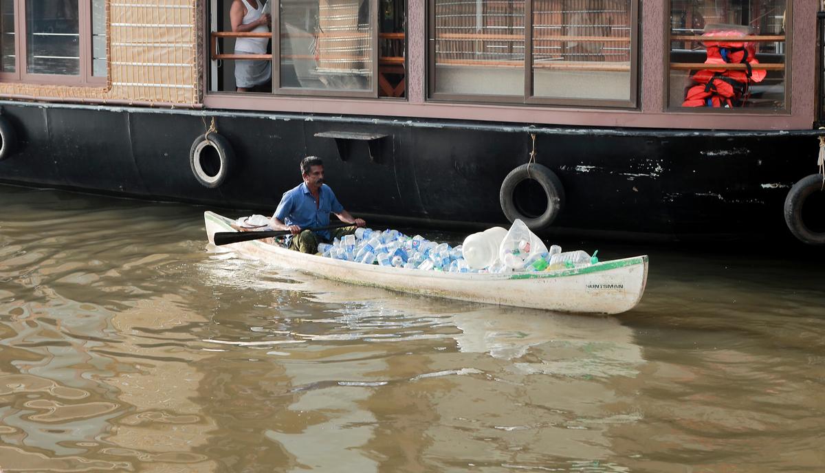 Suresh Kumar collecting plastic waste from Vembanad backwaters.