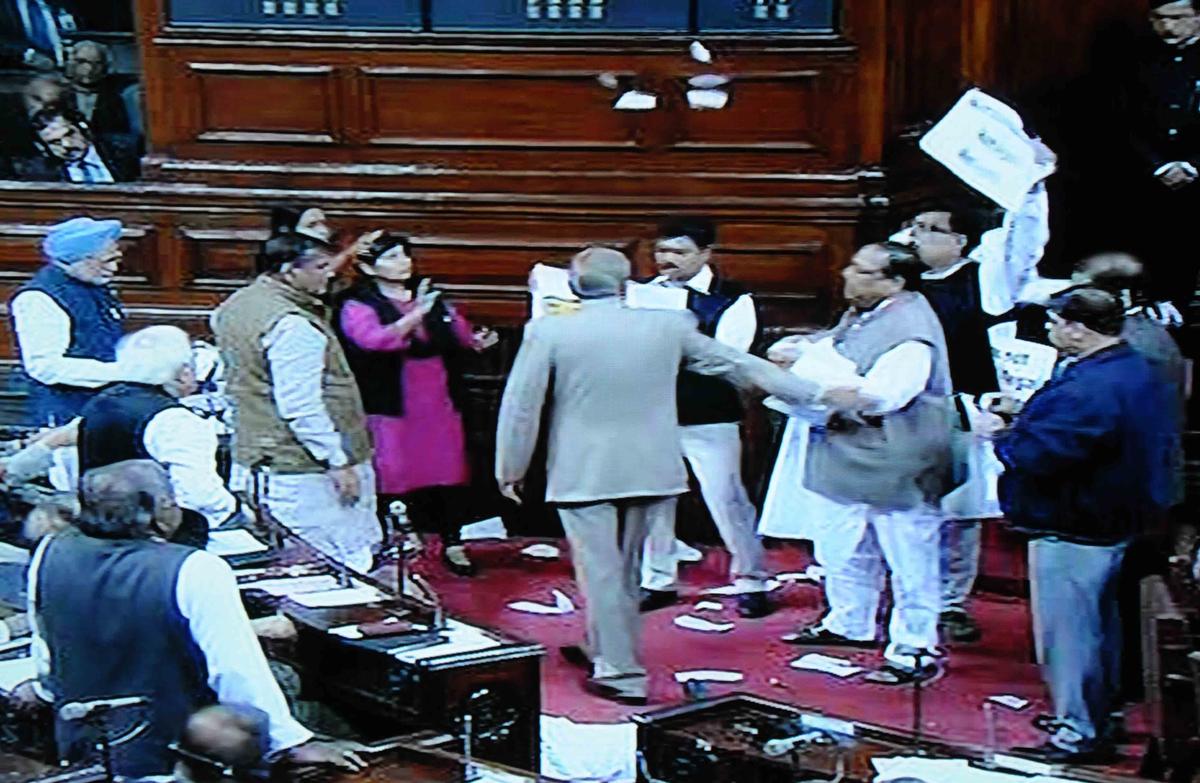 Former Prime Minister Manmohan Singh speaking during debate in Rajya Sabha, even the Well of the Upper House virtually turned into a battlefield with anti-Telangana protestors displaying huge placards opposing the Bill and creating an uproar. File