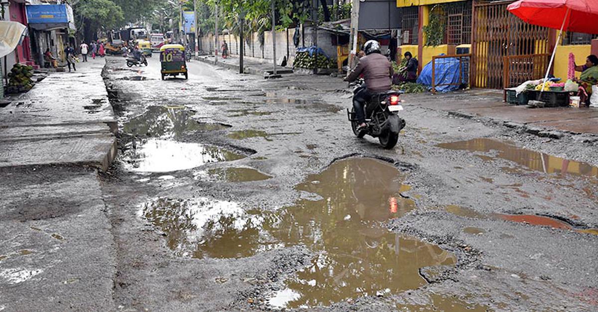 Potholes seen on Palace Guttahalli main road in Bengaluru.  file photo
