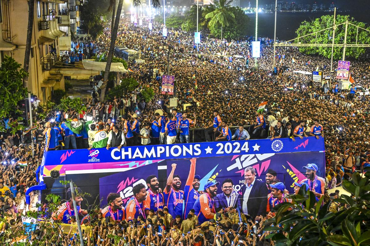 Team India arrives in an open bus during the victory parade at Marine Drive near Wankhede Stadium in Mumbai. 