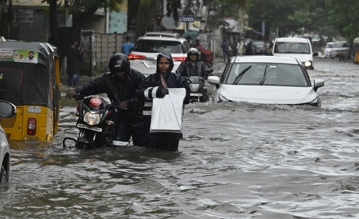 Vehicles wade through stagnanted rain water at Brindavan Street Extension, West Mambalam due to Fengal cyclone in Chennai.