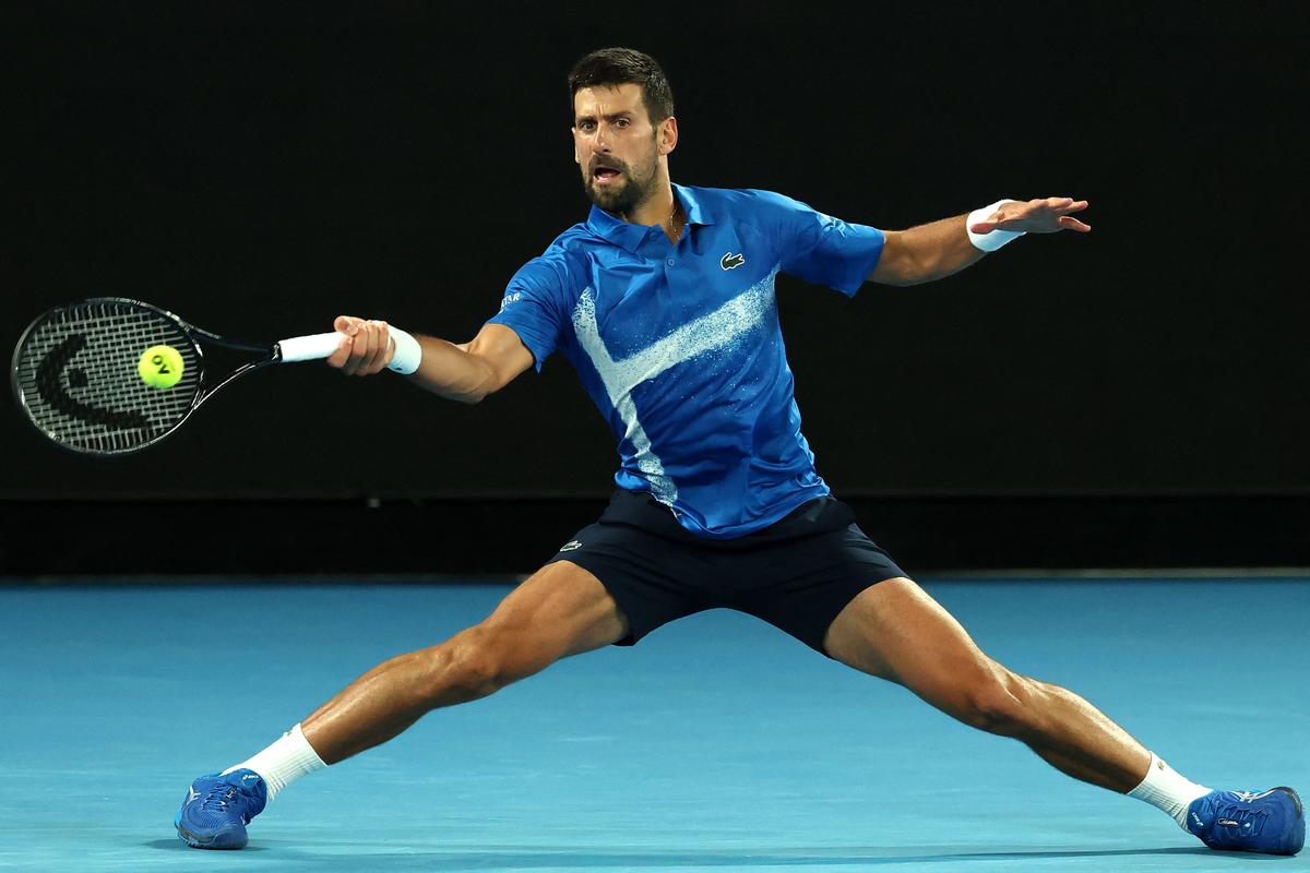 Serbia’s Novak Djokovic hits a return against USA’s Nishesh Basavareddy during their men’s singles match on day two of the Australian Open tennis tournament in Melbourne on January 13, 2025.