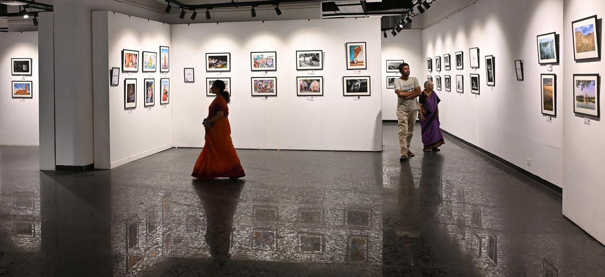 Visitors look at the photo exhibition in Lalit Kala Academy