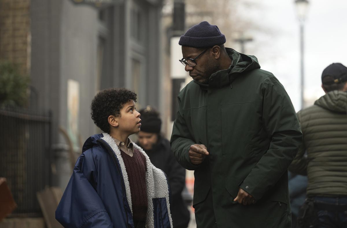 This image released by Apple TV+ shows Elliott Heffernan, left, and filmmaker Steve McQueen on the set of “Blitz.”