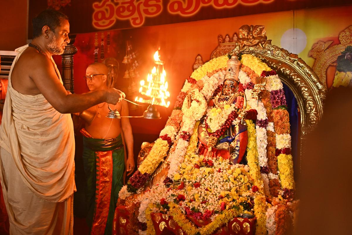 A priest offering harati to the processional deity Goddess Kanaka Durga in Sri Katyayani Devi Alankaram atop Indrakeeladri in Vijayawada on Thursday. 