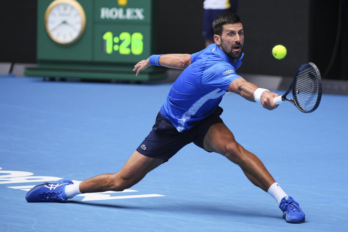 Novak Djokovic of Serbia plays a backhand return to Jaime Faria of Portugal during their second round match at the Australian Open tennis championship in Melbourne, Australia, on January 15, 2025. 