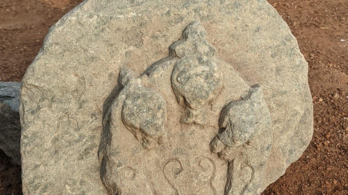 Stone carving of three-headed serpent among relics found during excavation in Lakkundi