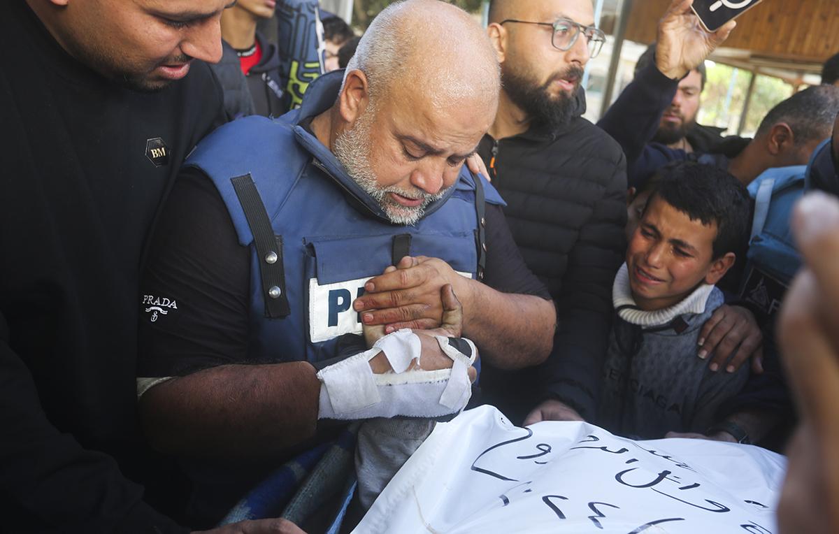 Al Jazeera journalist Wael Dahdouh holds the hand of his son Hamza, who also worked for Al Jazeera and who was killed in an Israeli airstrike in Rafah, Gaza Strip, Sunday, Jan. 7, 2024. Dahdouh lost his wife, two other children, and a grandson earlier in the war and nearly killed himself. Al Jazeera journalist Wael Dahdouh holds the hand of his son Hamza, who also worked for Al Jazeera and who was killed in an Israeli airstrike in Rafah, Gaza Strip, Sunday, Jan. 7, 2024. Dahdouh lost his wife, two other children, and a grandson earlier in the war and nearly killed himself.