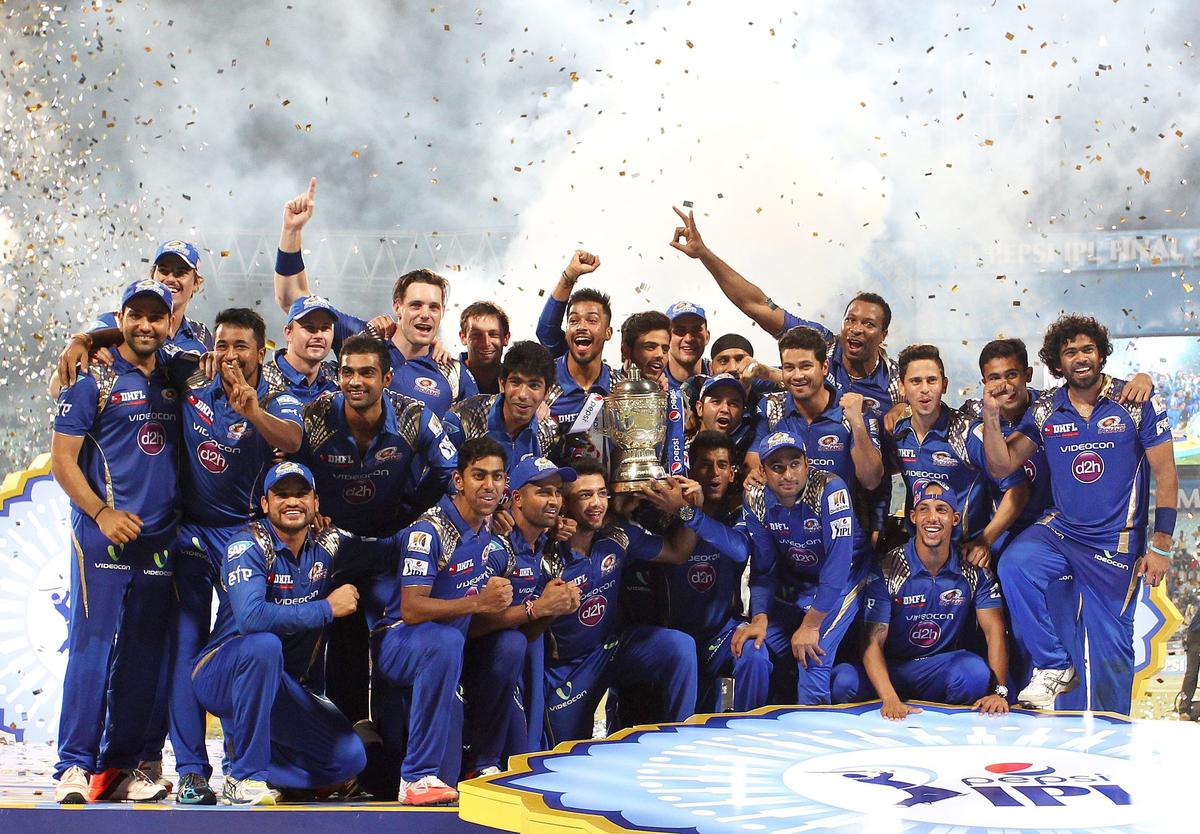 MI team celebrates with trophy after the final of the IPL 8 between Mumbai Indians and Chennai Super Kings at Eden Gardens Stadium in Kolkata