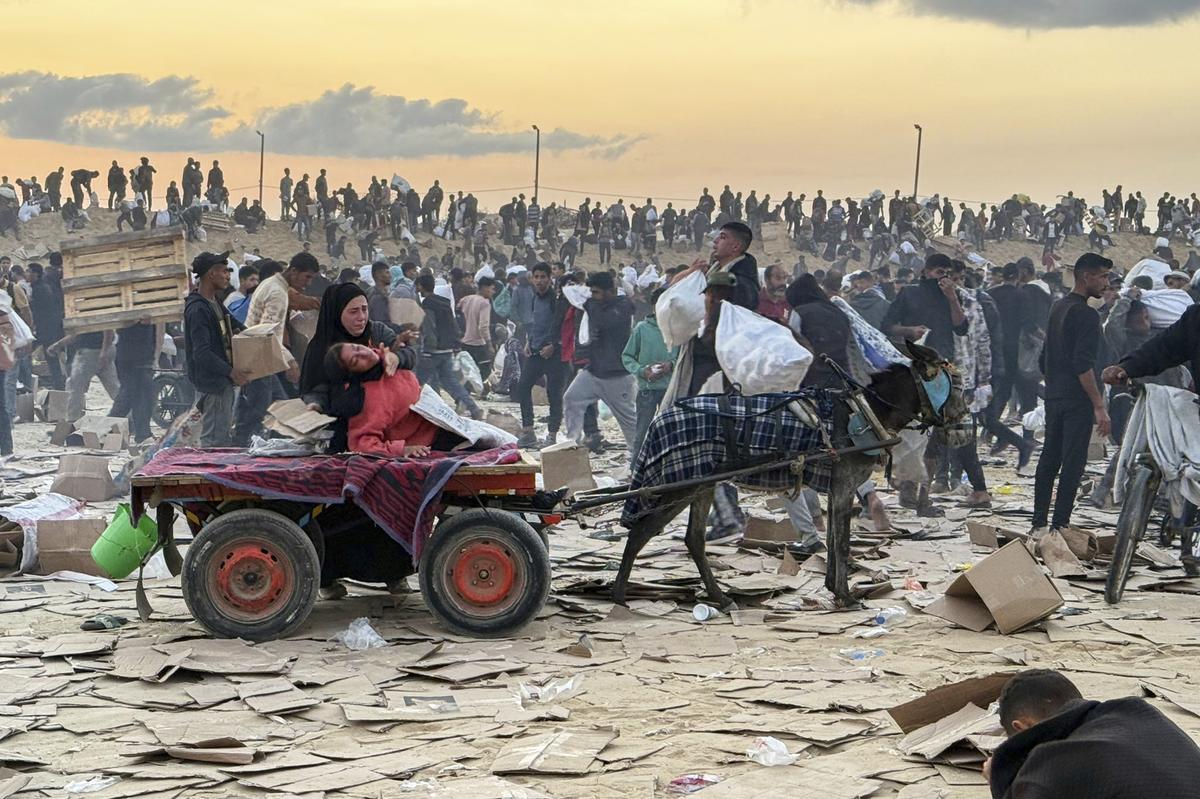 This photo, provided by an American contractor on condition of anonymity because they were revealing their employers’ internal operations, shows a woman slumped over in a donkey cart after the contractor said she was hit in the head with part of a stun grenade at a food distribution site in Gaza run by the Gaza Humanitarian Foundation in June 2025. 