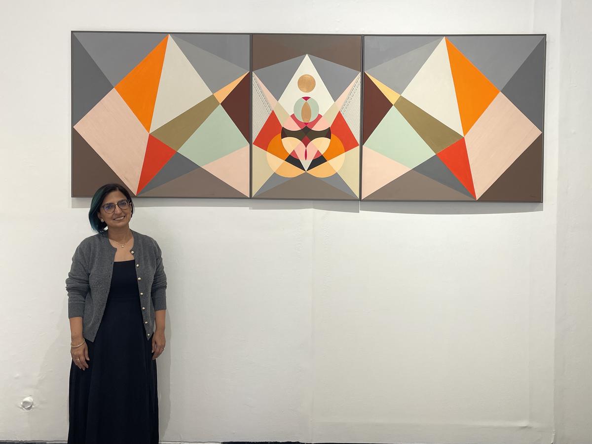 Artist Neerja Chandna Peters with her artwork at her solo exhibition Roopa Bheda - Secrets of Form at Bikaner House, New Delhi