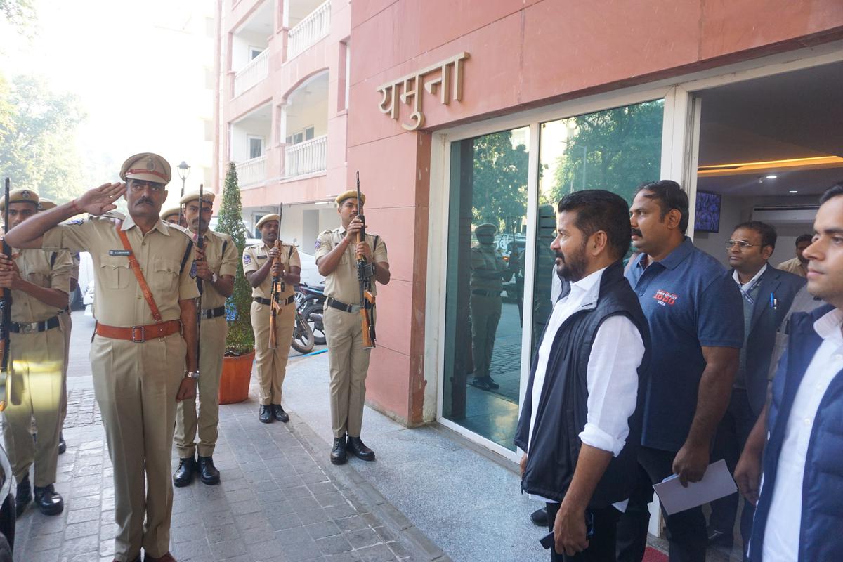 Telangana Congress chief A Revanth Reddy, who was named as the new Chief Minister of the State, receives a gaurd of honour on his arrival at Yamuna Apartment, in New Delhi, on Wednesday.