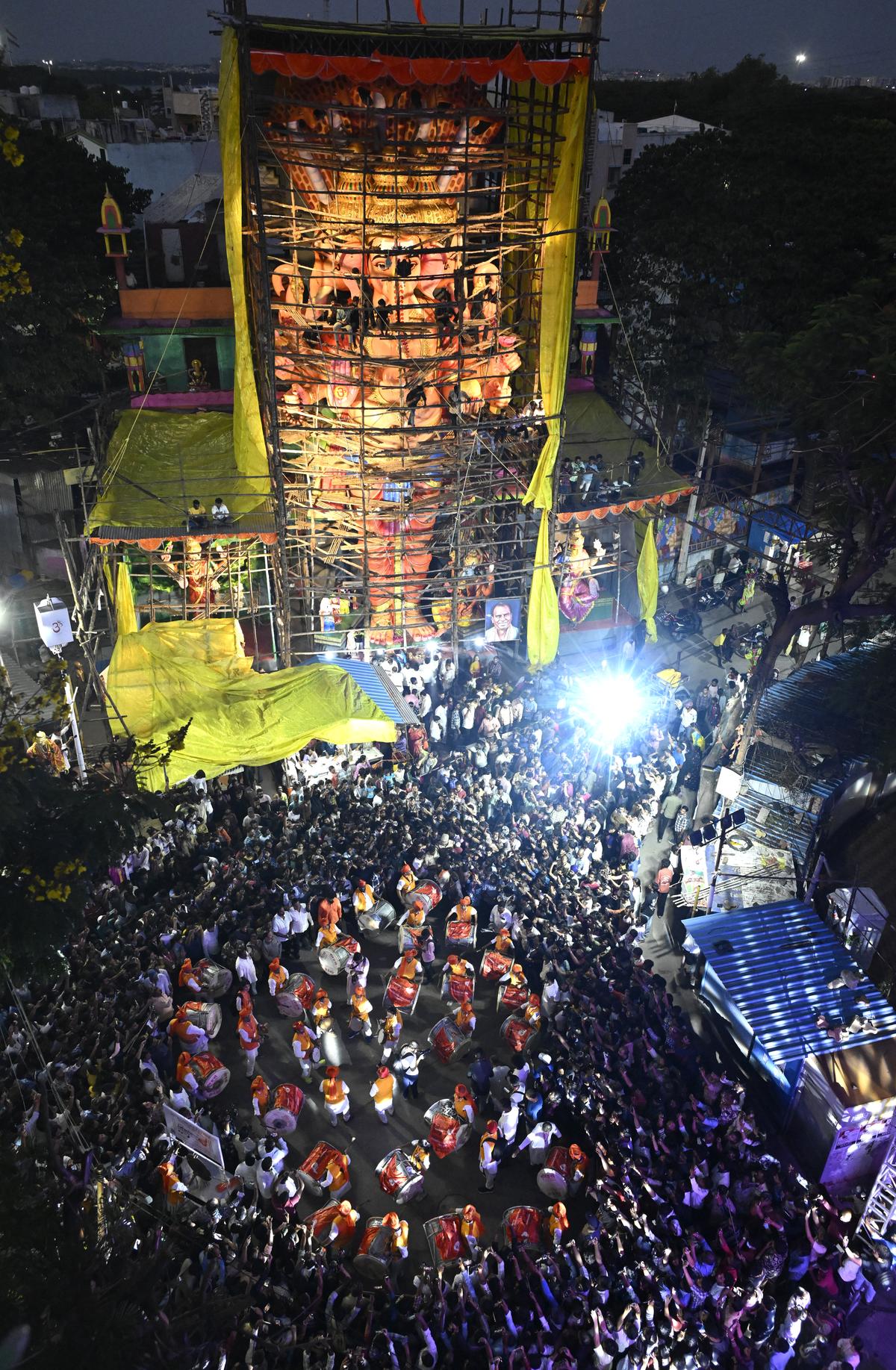 Devotees gather in large numbers as drummers perform near the Khairatabad Ganesh pandal in Hyderabad on Monday.