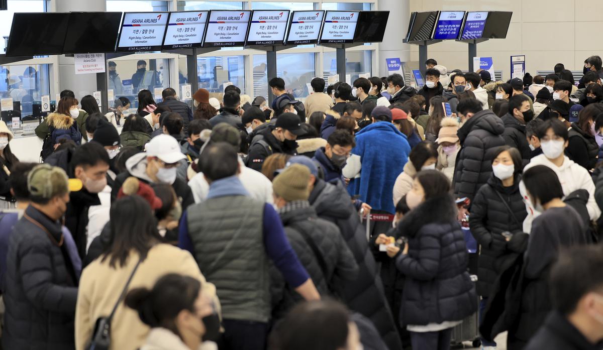 Passengers wait for their flight tickets at Jeju International Airport on Jeju Island, South Korea.