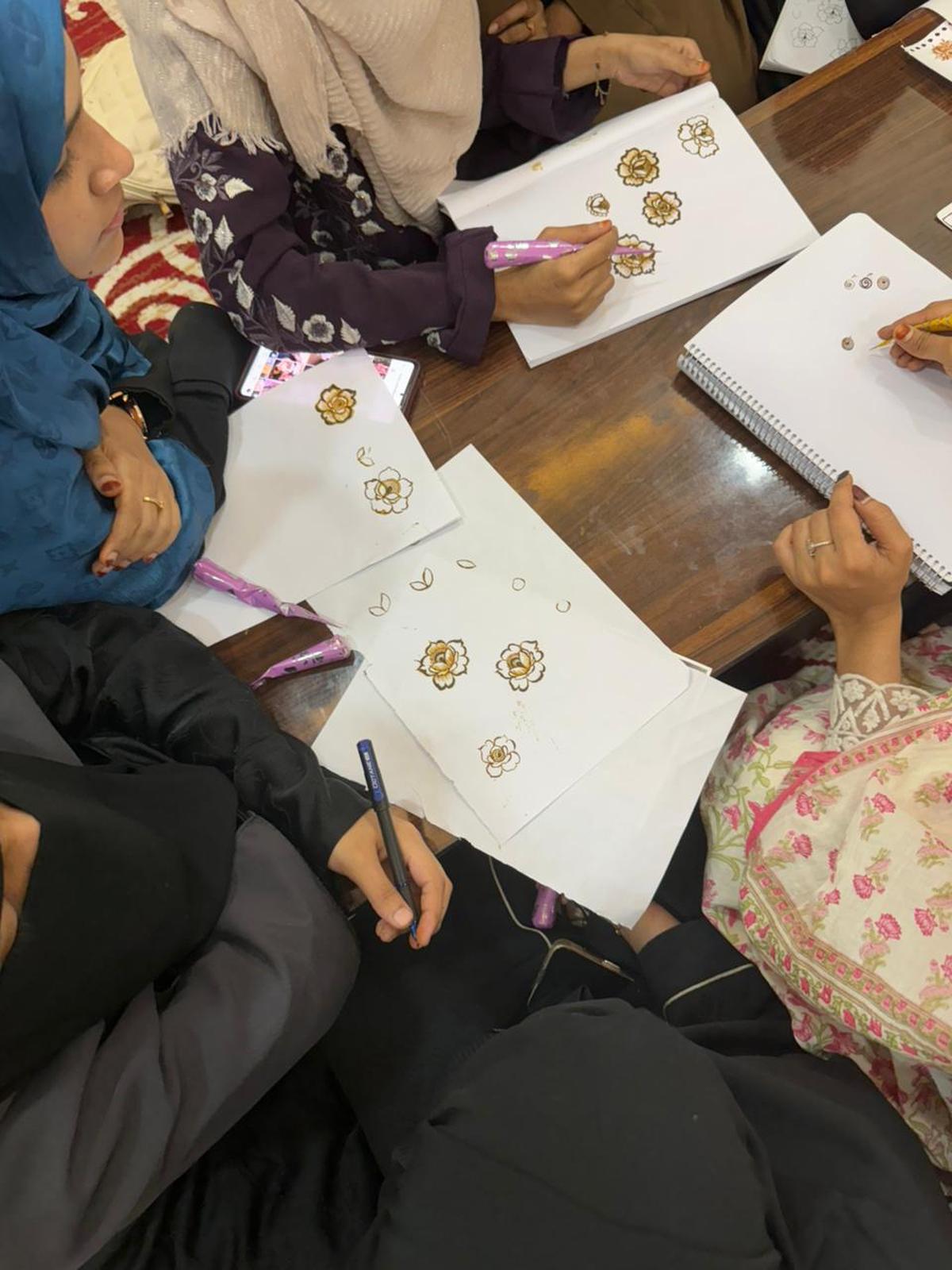 Young women train on trends in makeup and mehendi artistry. Young women train on trends in makeup and mehendi artistry.
