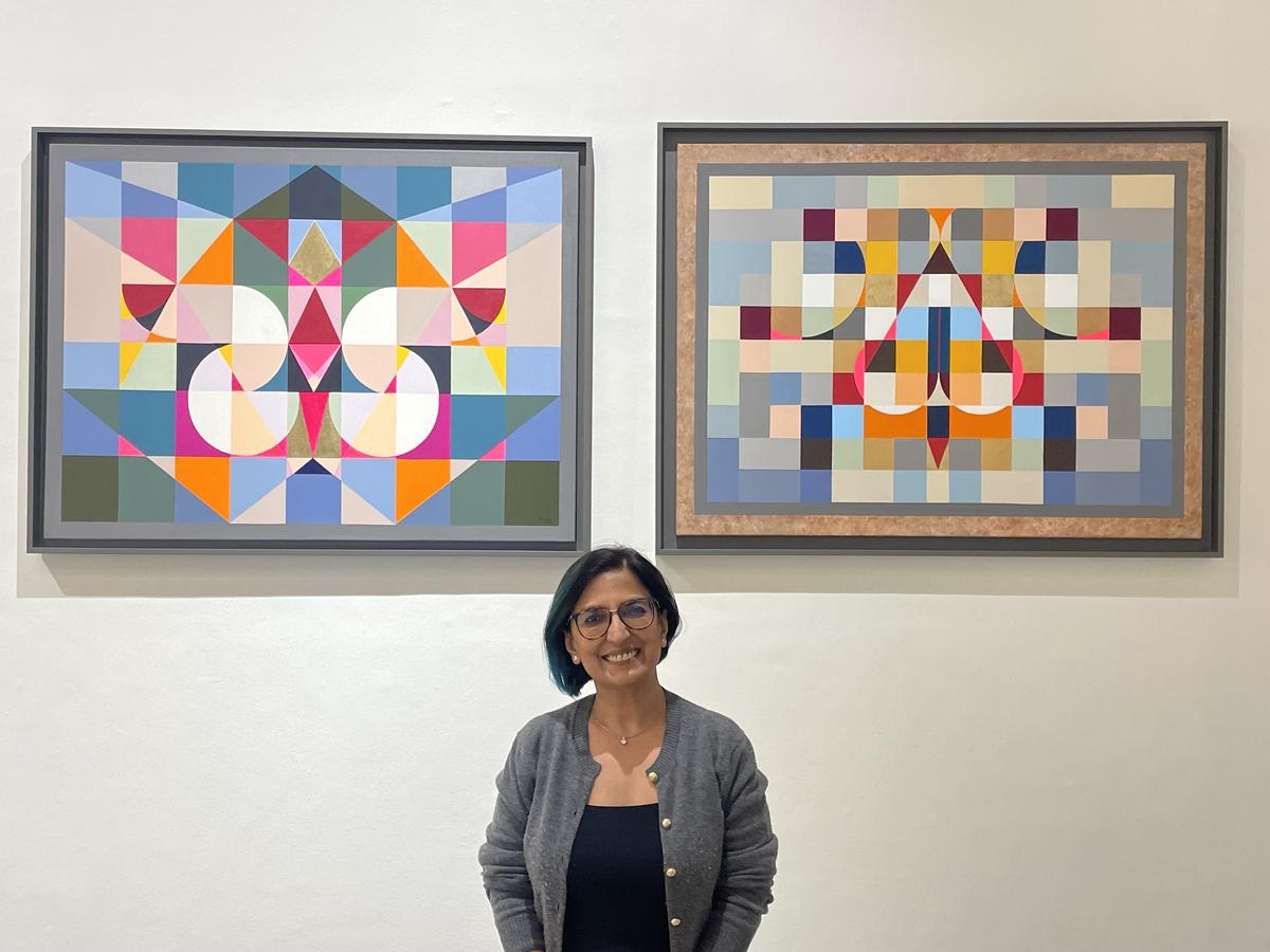 Artist Neerja Chandna Peters with her artwork at her solo exhibition Roopa Bheda - Secrets of Form at Bikaner House, New Delhi