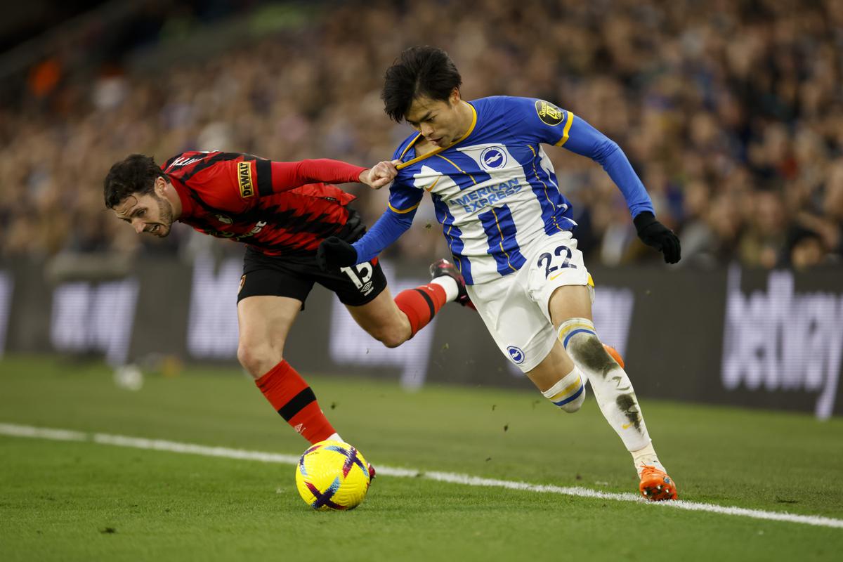 Bournemouth’s Adam Smith, left, chases for the ball alongside Brighton’s Kaoru Mitoma during the English Premier League soccer match between Brighton and Hove Albion and Bournemouth at the Amex Stadium in Brighton, England, Saturday, Feb. 4, 2023. 