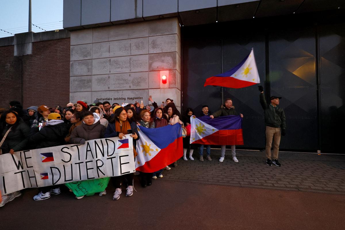 Supporters of former Philippine President Rodrigo Duterte wait for his arrival at the Scheveningen Prison following his arrest at the request of the International Criminal Court in The Hague, Netherlands, March 12, 2025.