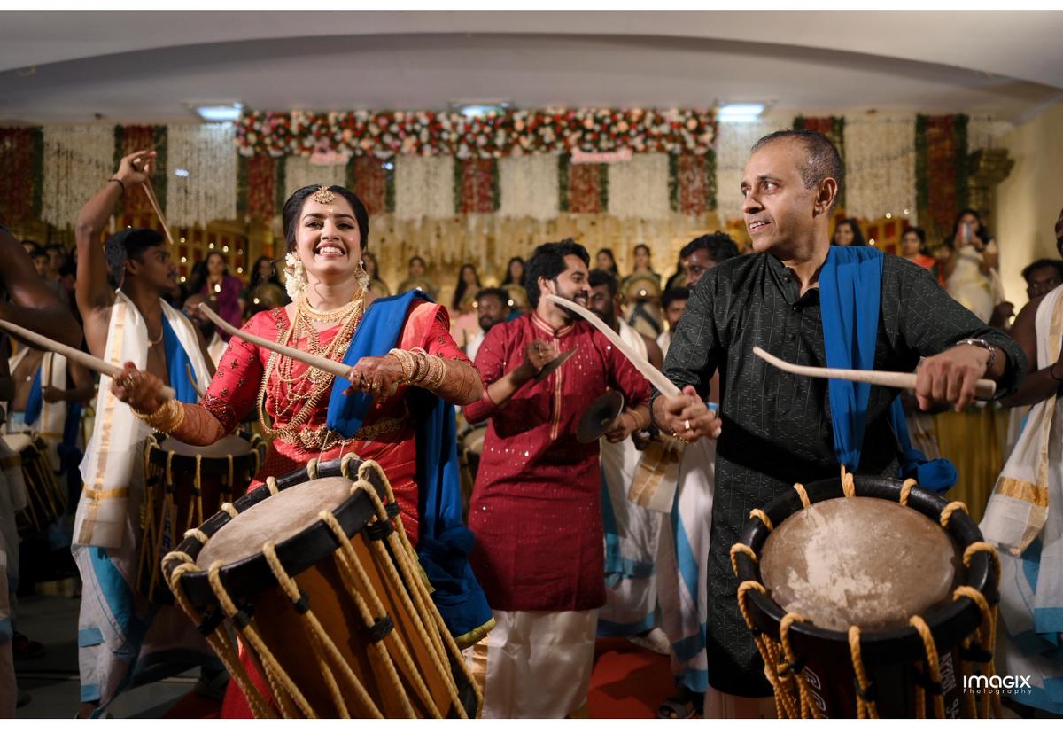 Shilpa Sreekumar playing the chenda at her wedding in Guruvayur along with Devanand chelot and Sreekumar Paliyath (right) 