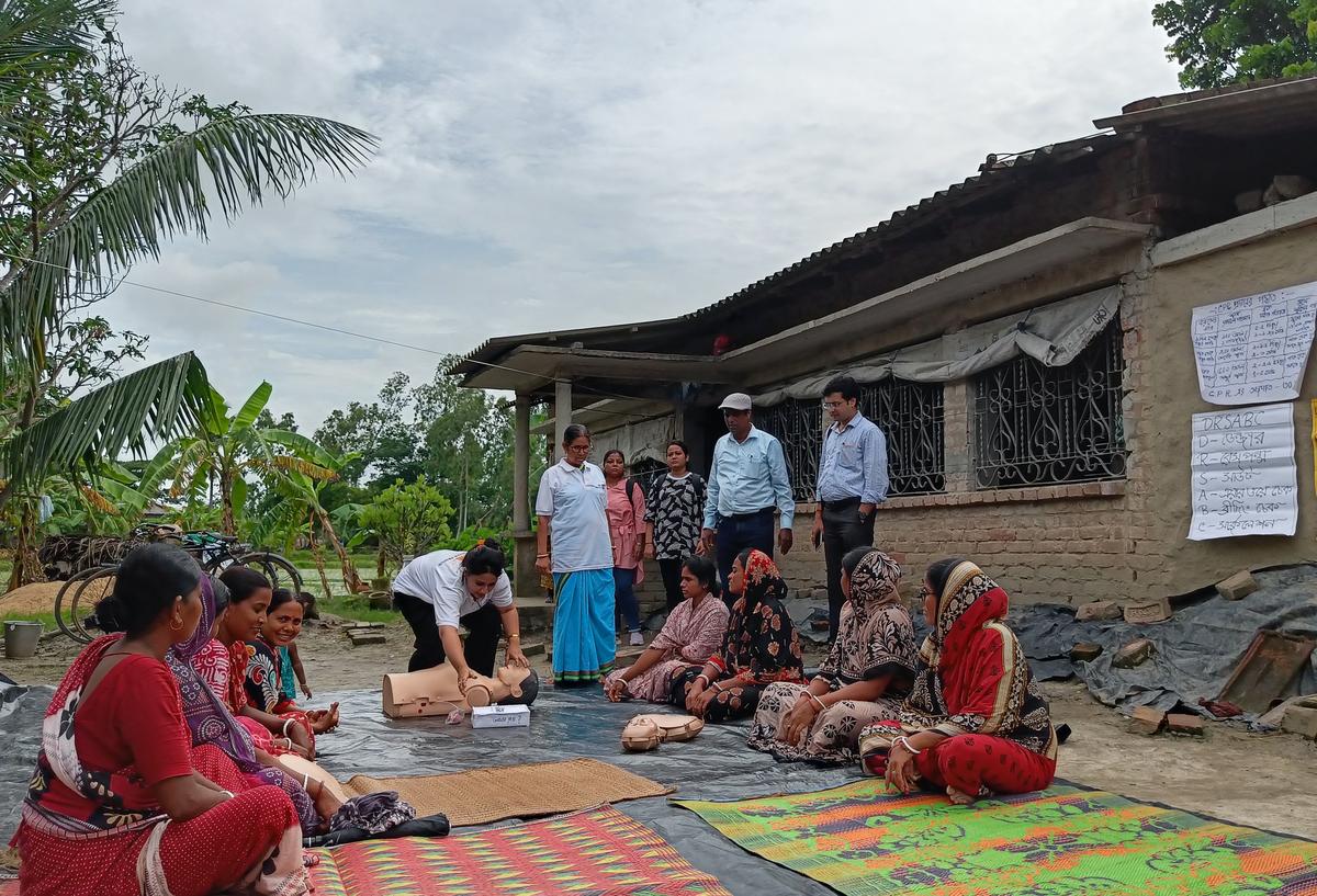 Community mothers in Kultali, Sundarban, learning to give CPR to young children.