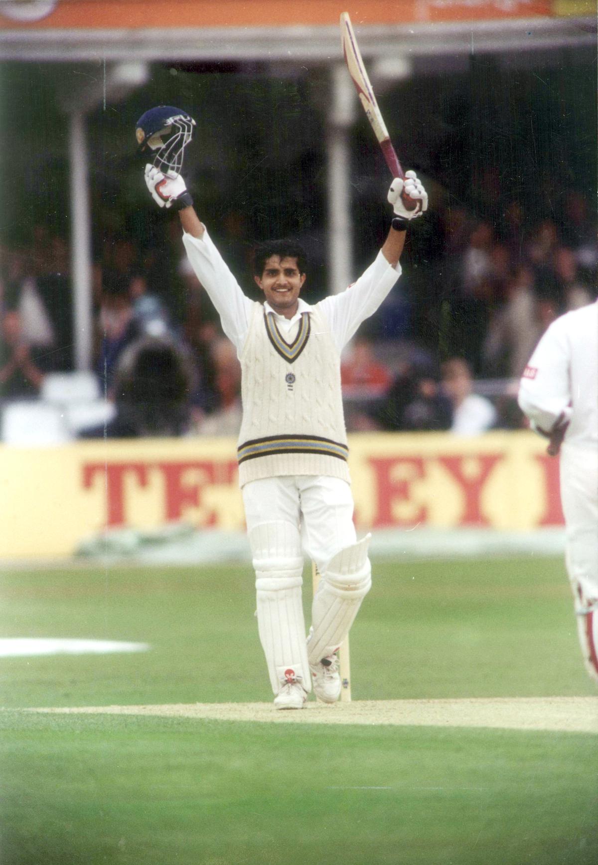 Indian batsman Sourav Ganguly raises his bat to acknowledge the crowd's cheers after scoring a century on the third day of the second test between India and England at Lords on June 22, 1996.