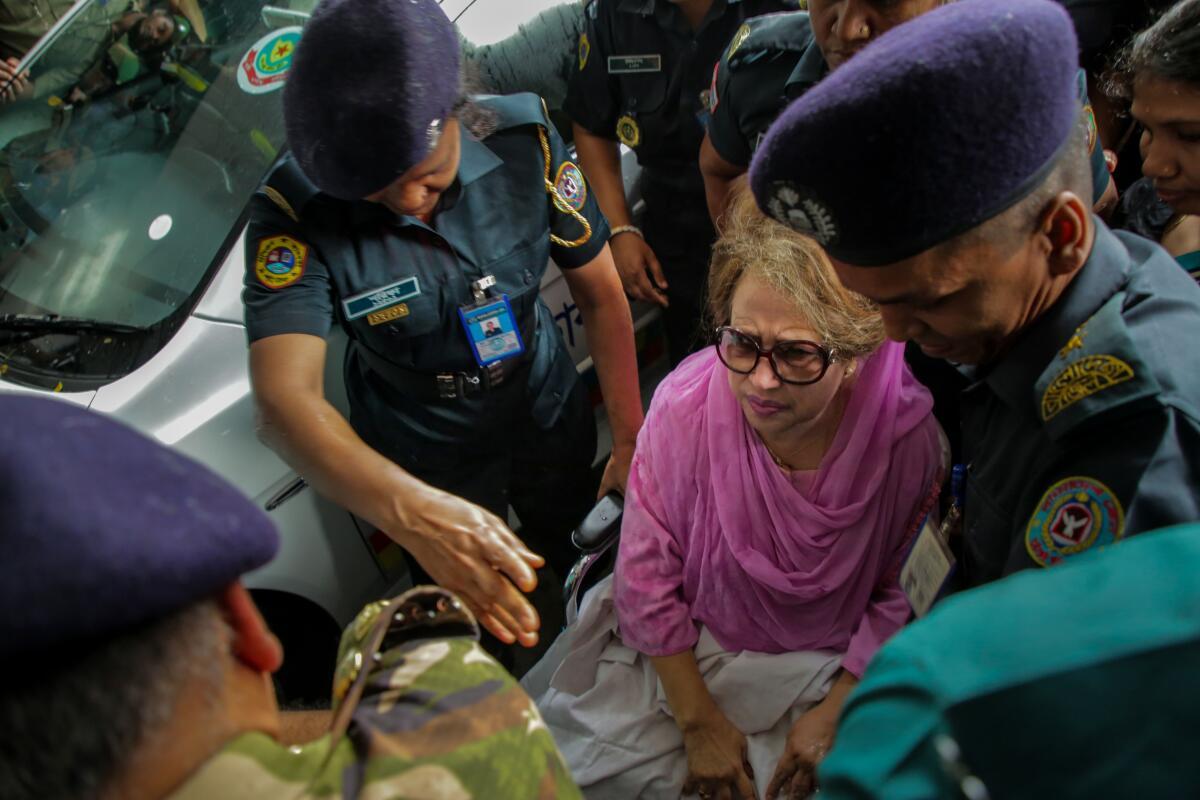 In this file photo taken on October 6, 2018, Bangladesh main opposition leader Khaleda Zia (C) looks on as she is escorted to Bangabandhu Sheikh Mujib Medical University (BSMMU) in Dhaka. 