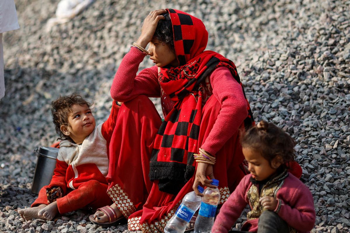 A relative of a stampede victim sits outside a hospital mortuary.