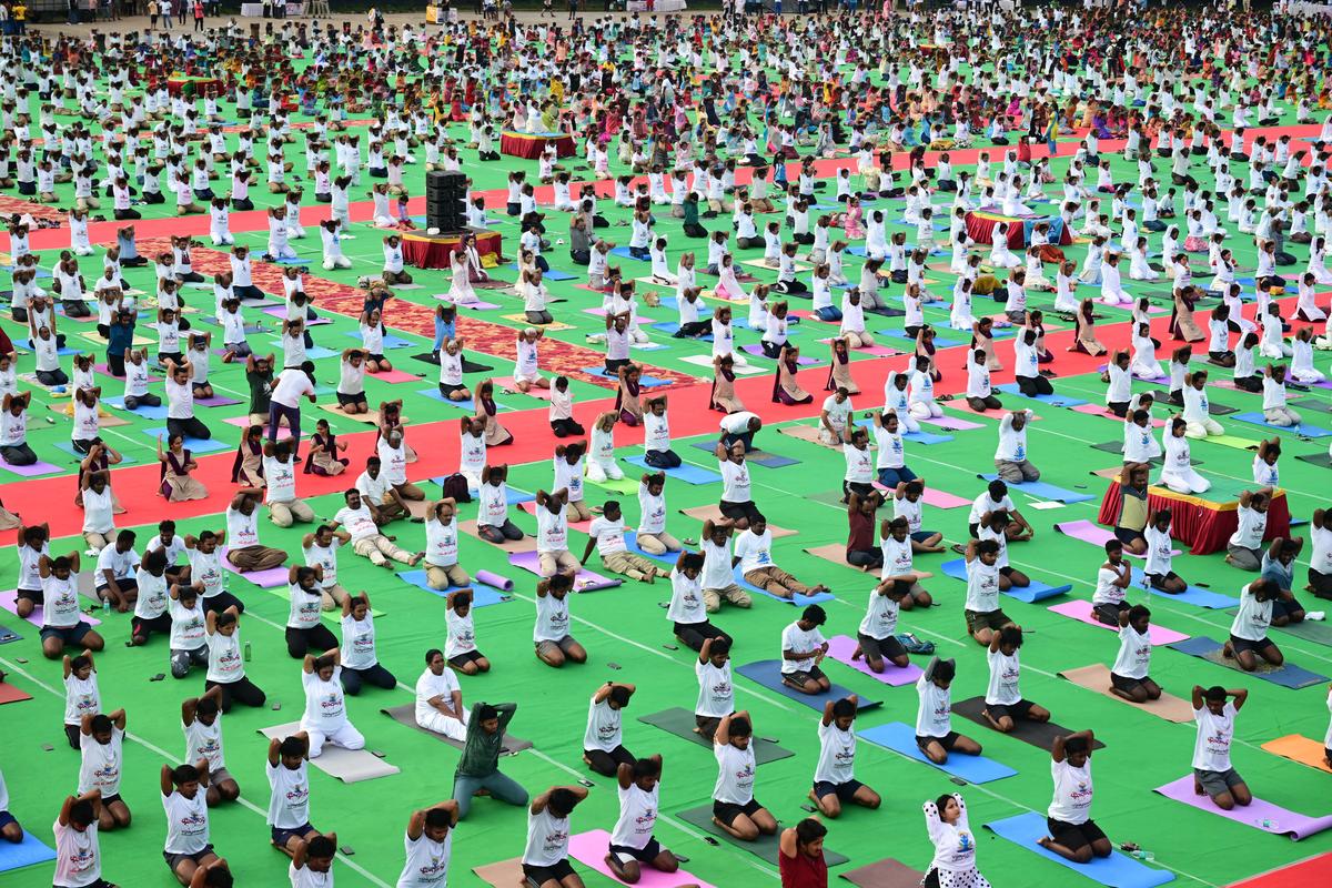 People performing yoga at the Indira Gandhi Municipal Stadium, in Vijayawada, on Saturday. 